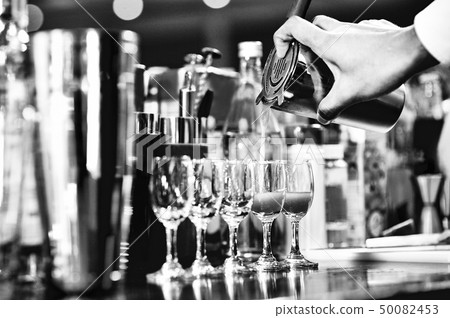 Bartender making alcohol cocktail at bar counter 50082453