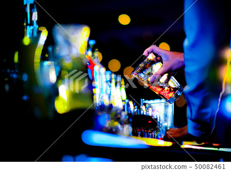 Bartender making alcohol cocktail at bar counter 50082461