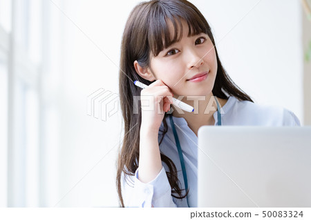 Young woman desk work 50083324