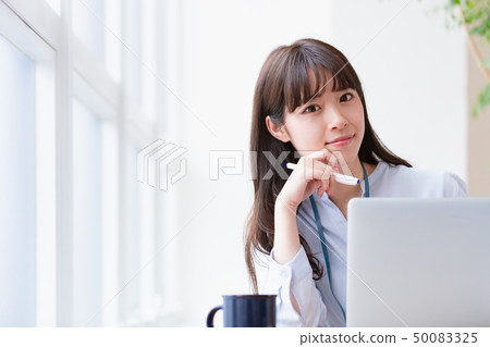 Young woman desk work 50083325