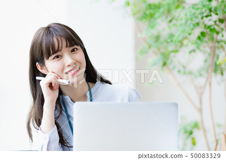 Young woman desk work 50083329