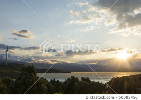 Electric wind generator turbine at sunset modern Electric wind generator turbine at sunset modern 50085456