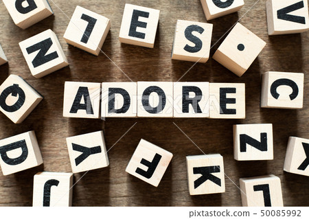 Wood letter block in word adore on wood background Wood letter block in word adore on wood background 50085992