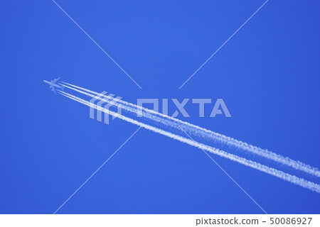 Jumbo jet flying in the blue sky and contrail 50086927