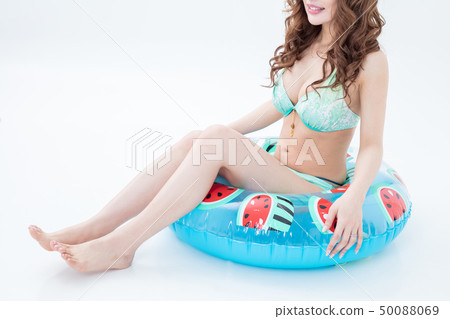 Beautiful woman cabaret of a brunette in a swimsuit with swimsuit shot on a white background in studio Beautiful woman cabaret of a brunette in a swimsuit with swimsuit shot on a white background in studio 50088069