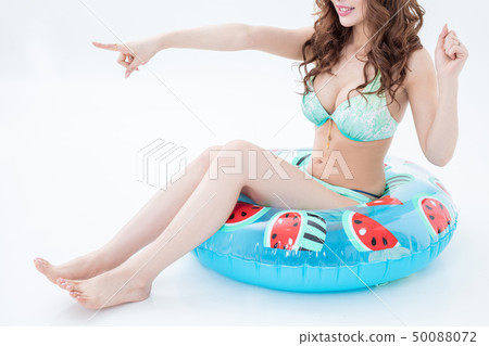 Beautiful woman cabaret of a brunette in a swimsuit with swimsuit shot on a white background in studio 50088072