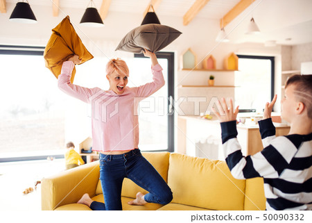 A young woman with two children having fun at home. A young woman with two children having fun at home. 50090332