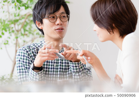 Couple looking at smartphone Couple looking at smartphone 50090906