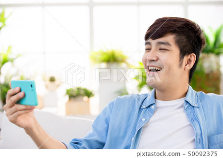 man watch video with phone man watch video with phone 50092375