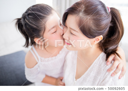 Daughter kiss mom tenderly Daughter kiss mom tenderly 50092605