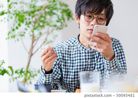 早餐場景男子看智能手機 早餐場景男子看智能手機 50093481