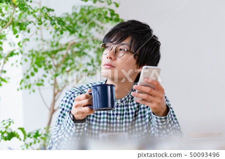 Breakfast scene Men watching smartphone 50093496