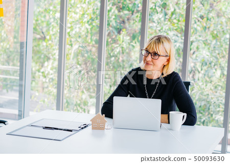 Businesswoman looking away in office Businesswoman looking away in office 50093630