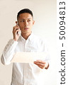 A man who makes a phone call 50094813