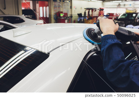Car detailing - Hands with orbital polisher in auto repair shop. Selective focus. Car detailing - Hands with orbital polisher in auto repair shop. Selective focus. 50096025