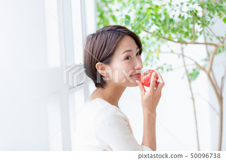 Woman with windowsill play with tomato Woman with windowsill play with tomato 50096738