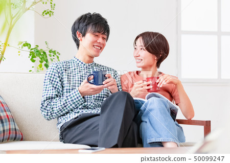 Couple couple relaxing on the couch Couple couple relaxing on the couch 50099247