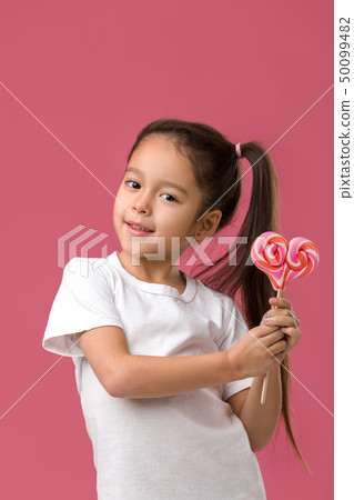 Beautiful cute little girl with a lollipop Beautiful cute little girl with a lollipop 50099482