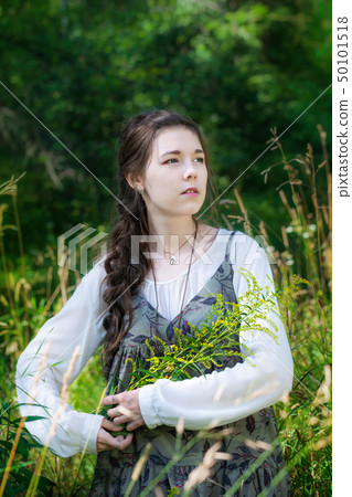 Woman herbalist collects medicinal herbs 50101518