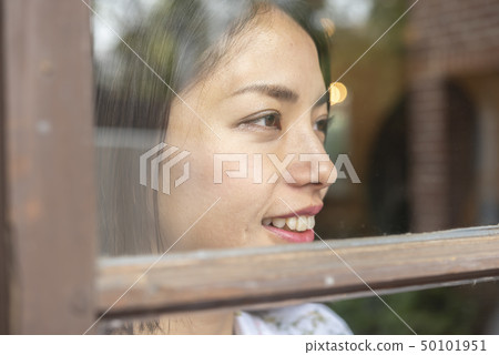 Lifestyle woman window look cafe 50101951