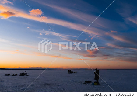 silhouettes of a fisherman with a fishing rod on a winter fishing silhouettes of a fisherman with a fishing rod on a winter fishing 50102139