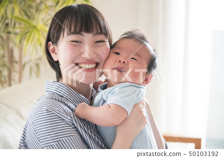 A young mother holding a baby Japanese parent and child 50103192