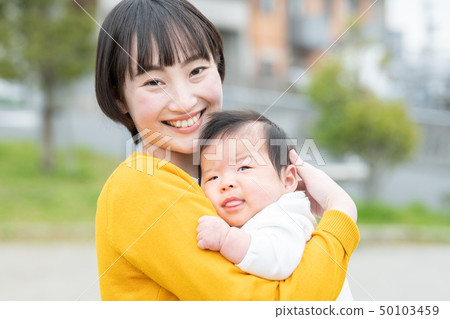 A young mother holding a baby Japanese parent and child 50103459