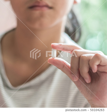 Teenager girl having pharmaceutical medical pill Teenager girl having pharmaceutical medical pill 50104263