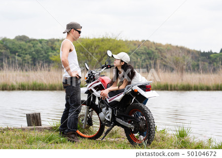 Motorcycle and couple 50104672