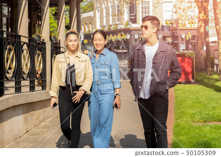 Happy mother and mixed race teen walking on the street in summer. Happy mother and mixed race teen walking on the street in summer. 50105309