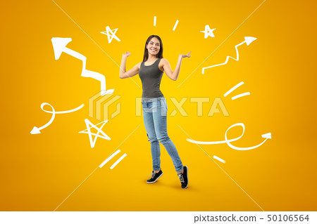 Young happy brunette girl wearing casual jeans and t-shirt with cartoon arrows, lines and stars on 50106564