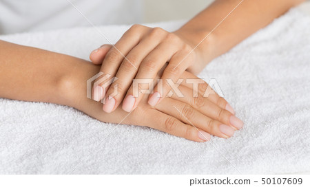 Woman getting manicure procedure in spa salon Woman getting manicure procedure in spa salon 50107609