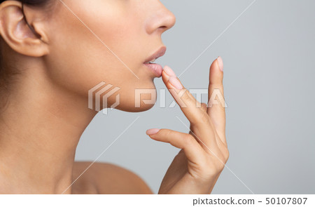 African woman in profile touching her lips African woman in profile touching her lips 50107807