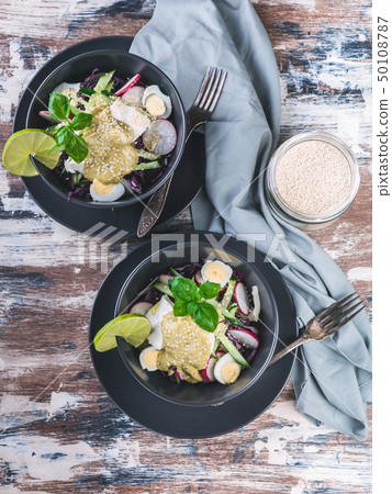 Top view fresh vegetable salad in a dark bowl. Top view fresh vegetable salad in a dark bowl. 50108787