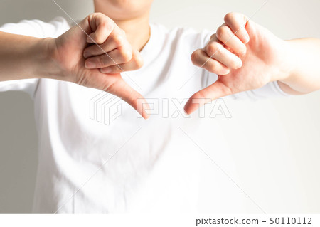 A person posturing two hands thumbs down. 50110112