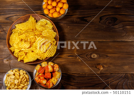 Mix of snacks for beer on wooden table 50110151