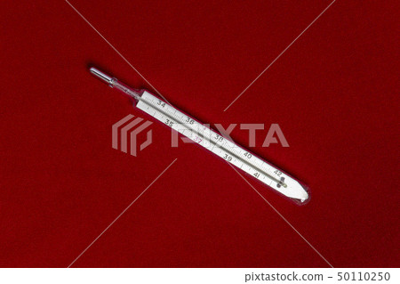 Mercury thermometer isolated on red fabric 50110250