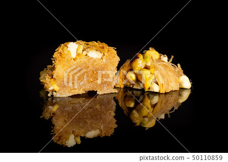 Lebanese baklava nest isolated on black glass Lebanese baklava nest isolated on black glass 50110859