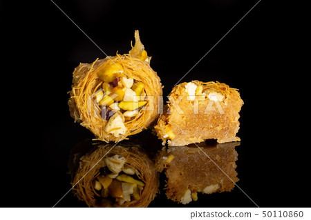 Lebanese baklava nest isolated on black glass Lebanese baklava nest isolated on black glass 50110860