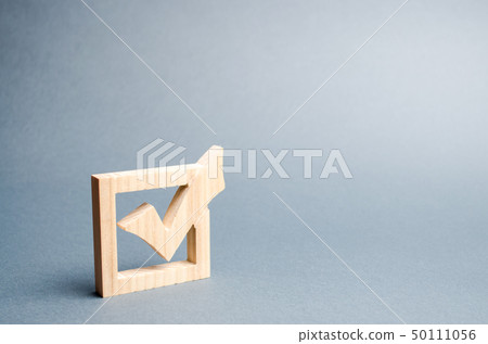 wooden checkmark for voting on elections  50111056