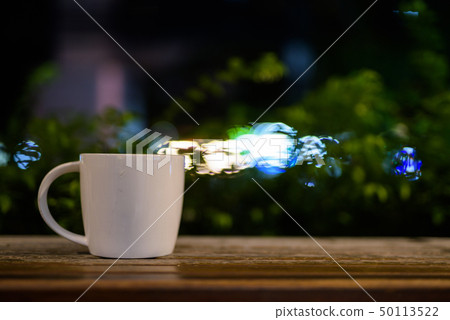 Coffee Cup On Wooden Table In Restaurant At Night Coffee Cup On Wooden Table In Restaurant At Night 50113522