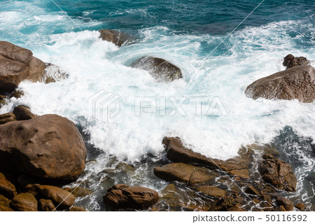 Big ocean splash near coast with rocks Big ocean splash near coast with rocks 50116592