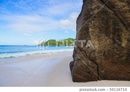 Huge rock on Seychelles sand beach day 50116710