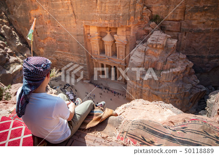 Asian man traveler sitting in Petra, Jordan Asian man traveler sitting in Petra, Jordan 50118889