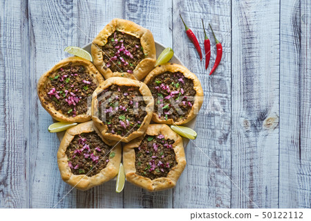 Open meat pies on a black background. Top view. Open meat pies on a black background. Top view. 50122112