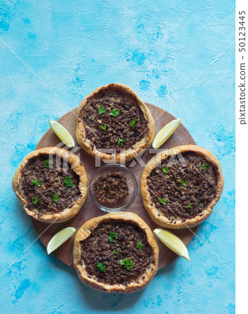 Traditional Lebanese meat pies on a blue table. Traditional Lebanese meat pies on a blue table. 50123445