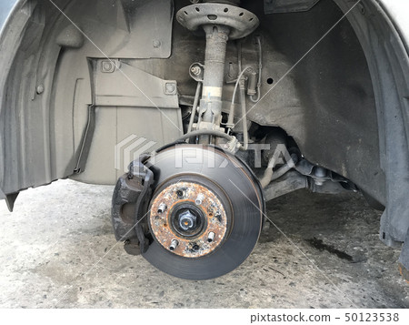 close up brake discs car without wheel and lift up close up brake discs car without wheel and lift up 50123538