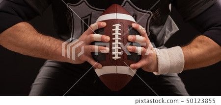 Cropped Image Of Sportsman Holding American Football Ball 50123855