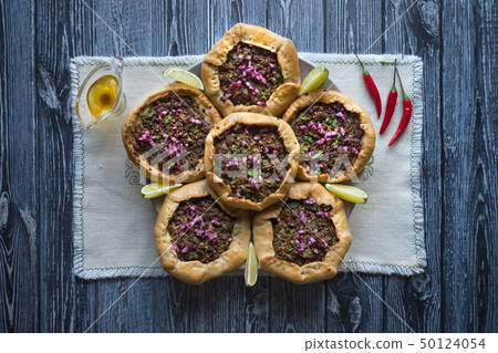 Open meat pies on dark wooden background. Top view 50124054