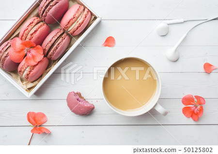 Cup of coffee, macaroon cookies in a box, flowers Cup of coffee, macaroon cookies in a box, flowers 50125802